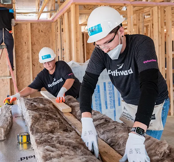Volunteers working on insulation for a home