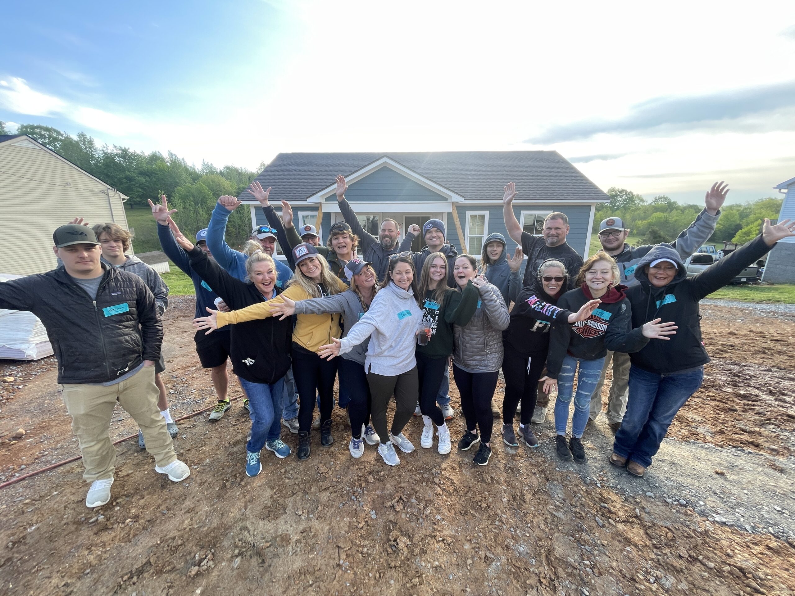 A Habitat for Humanity team in front of a house