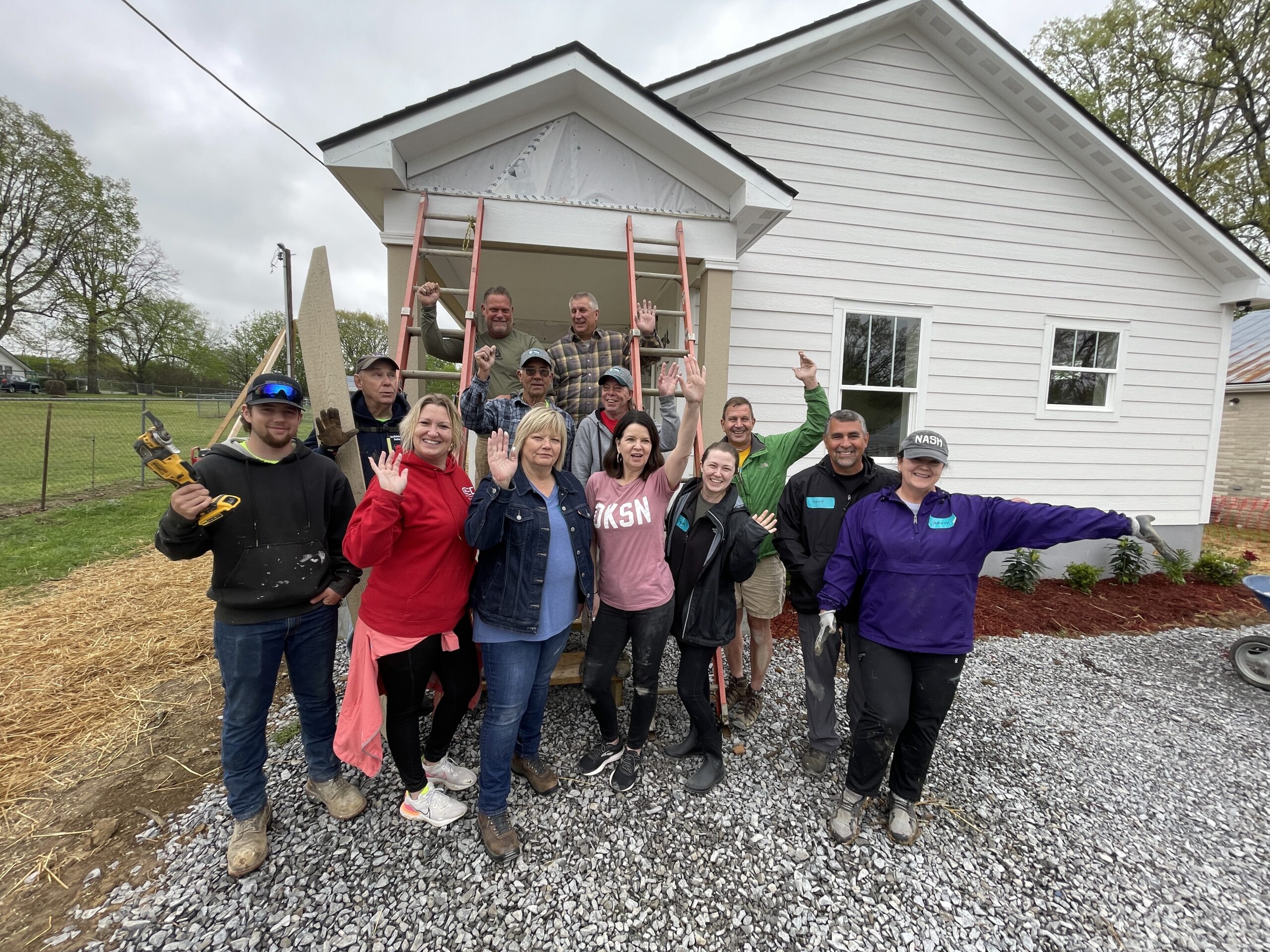 A Habitat for Humanity team with a completed house in Dickson, TN